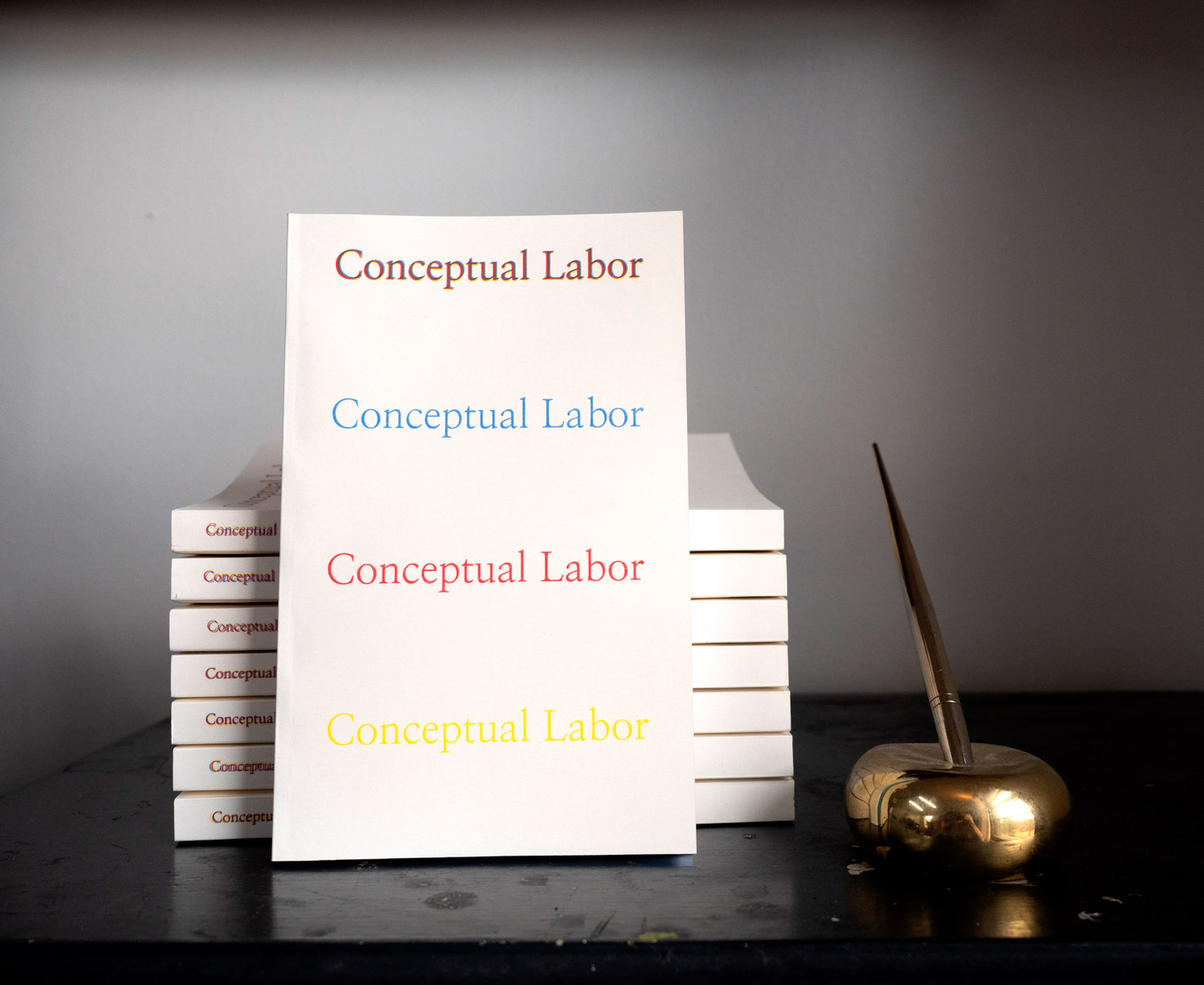 A stack of books with the title Conceptual Labor